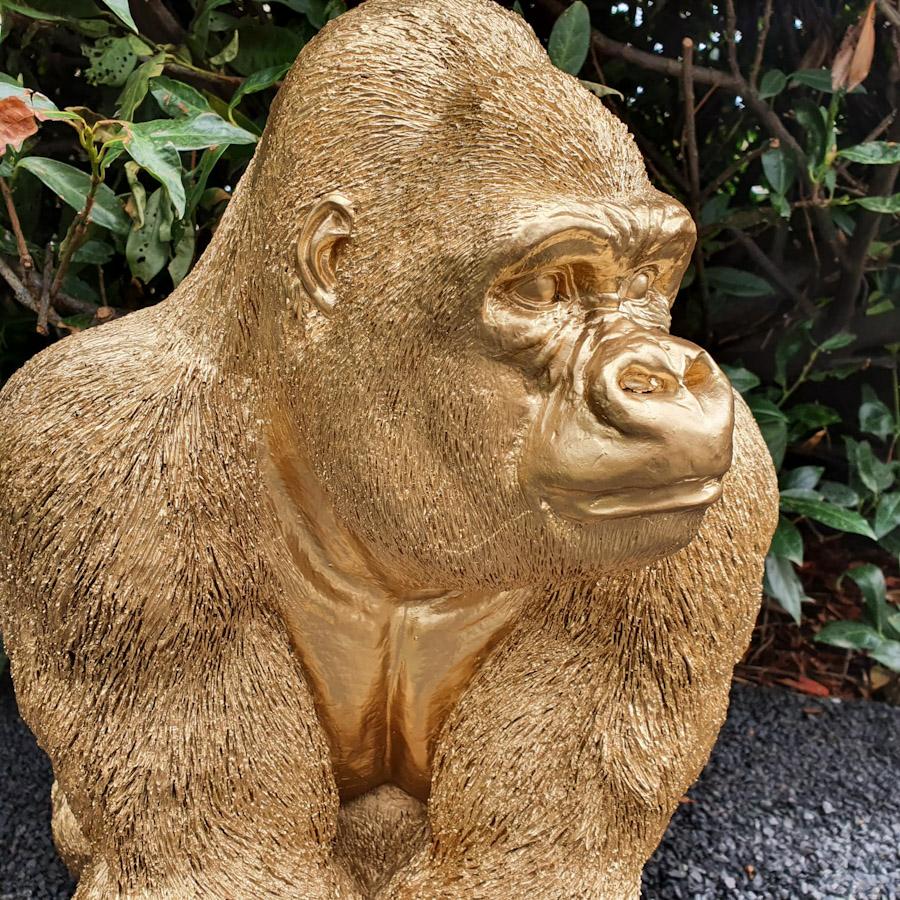 Goldener Gorilla auf der Lauer als Gartenfigur Nahaufnahme