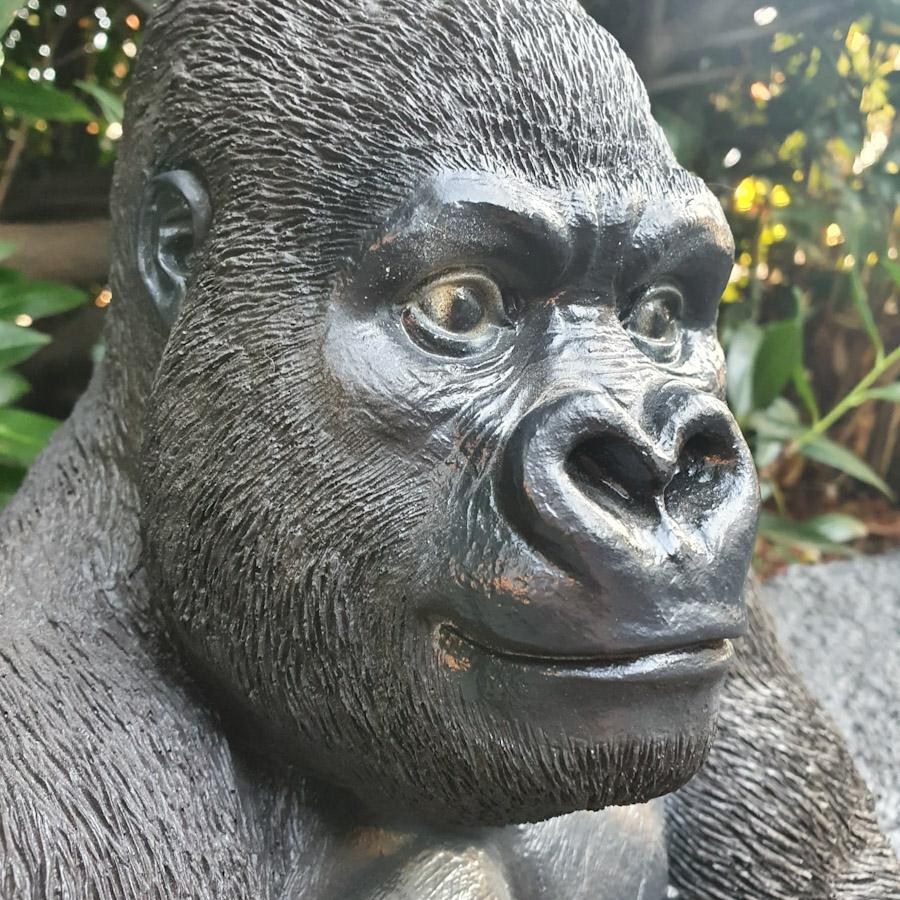 Gorilla sitzt als Gartenfigur Nahaufnahme
